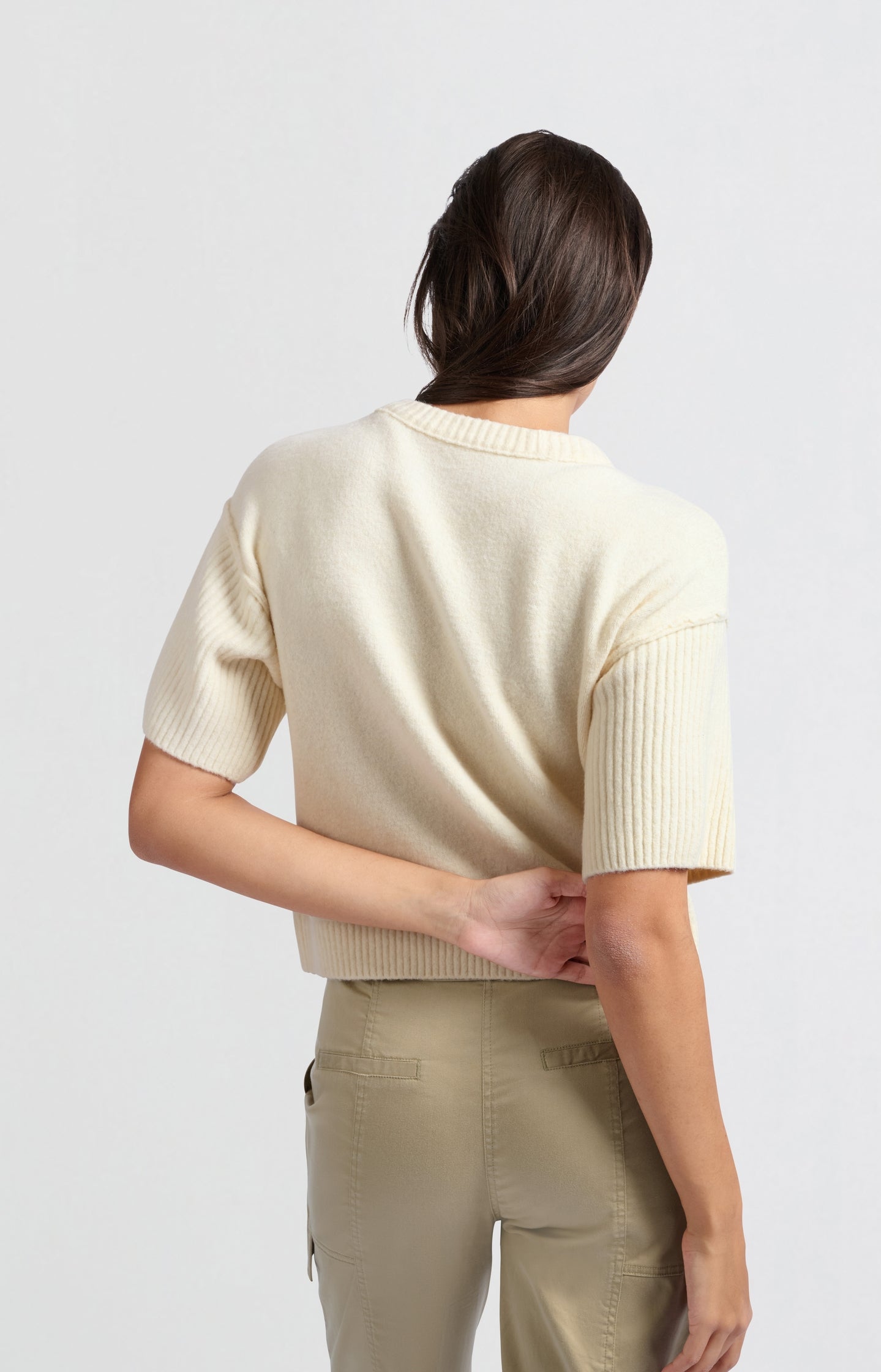 Cream-colored cardigan with short wide sleeves and round nec