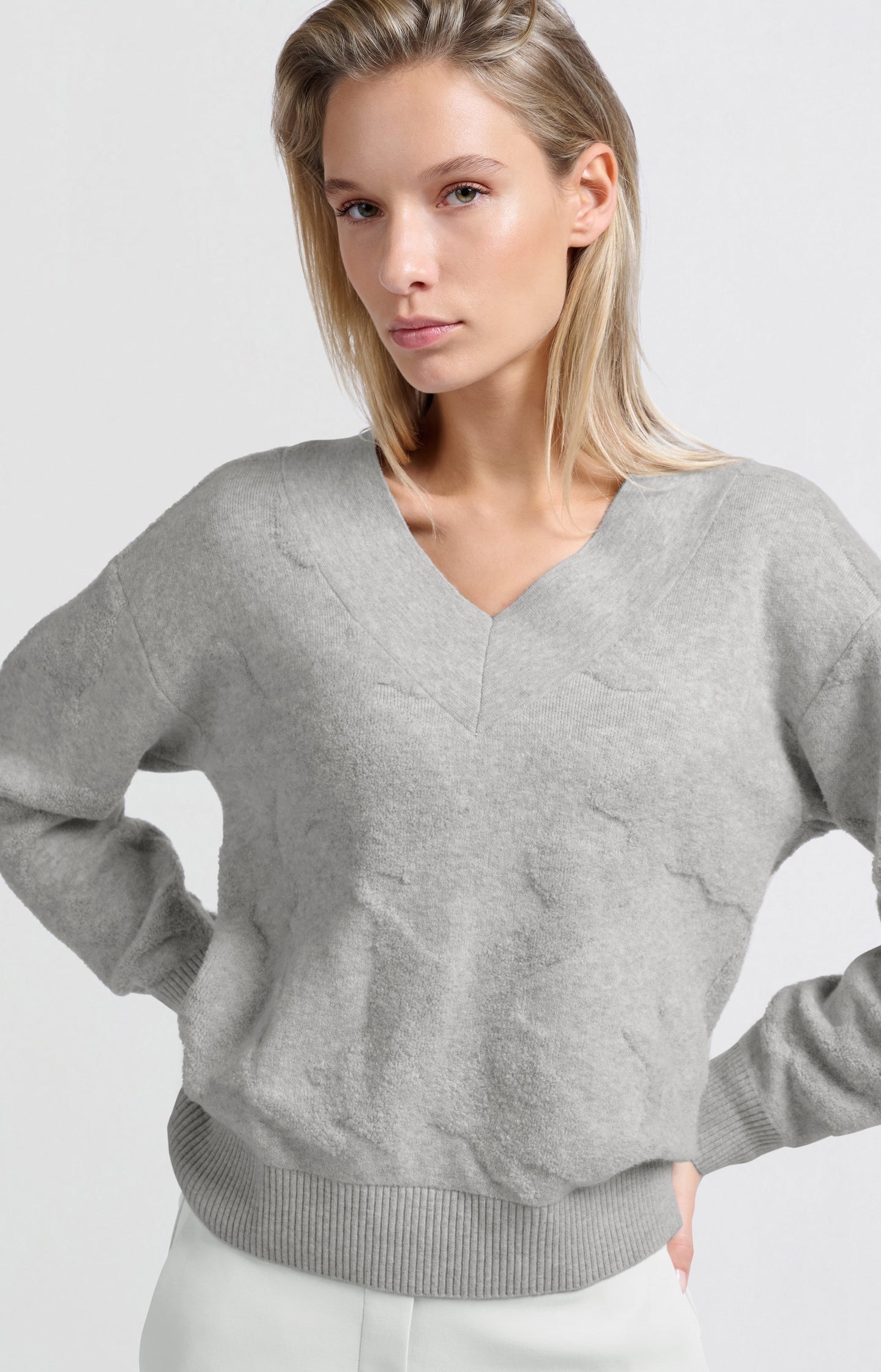 Knitted sweater with V-neck and textured pattern