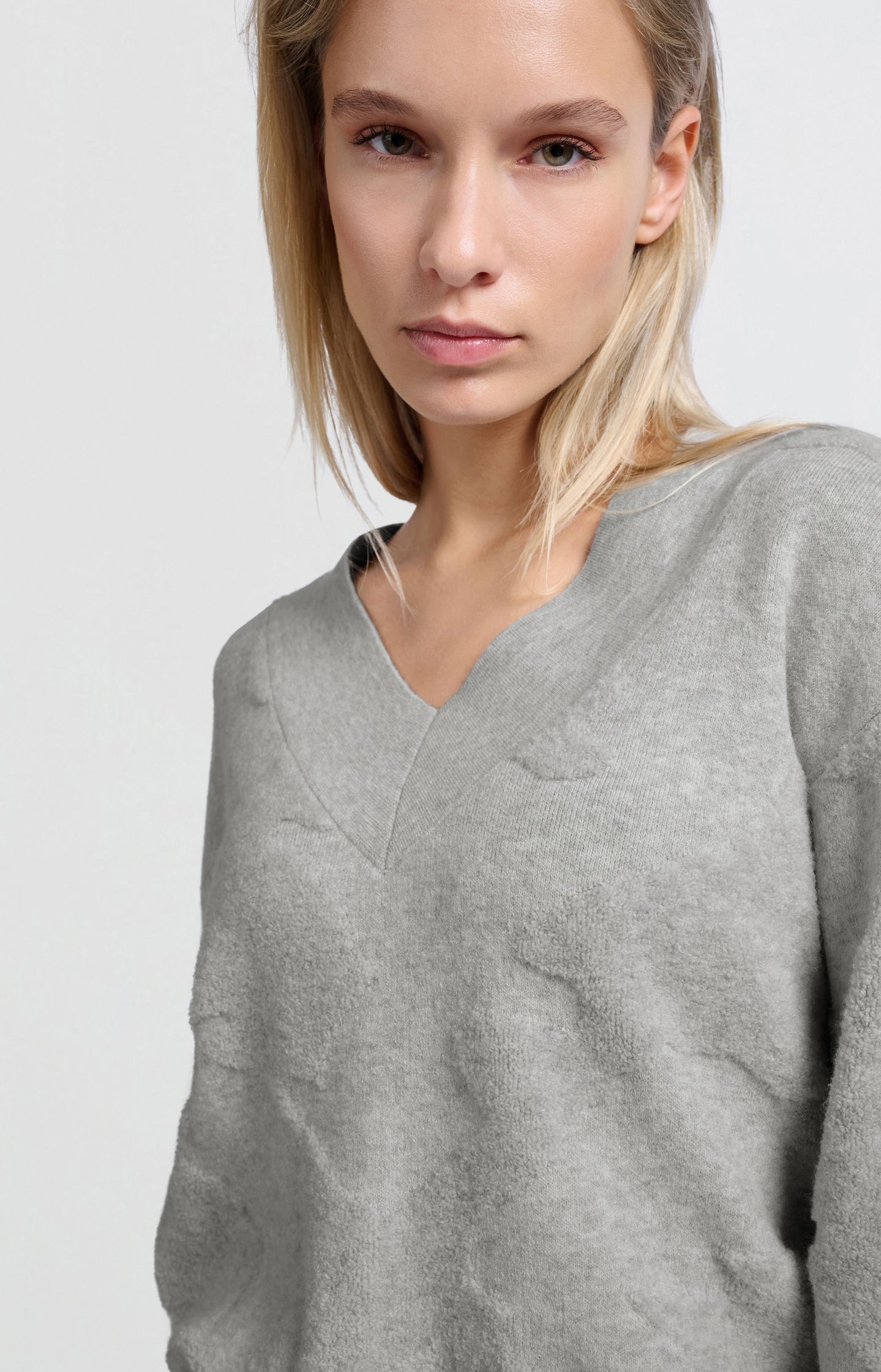 Knitted sweater with V-neck and textured pattern