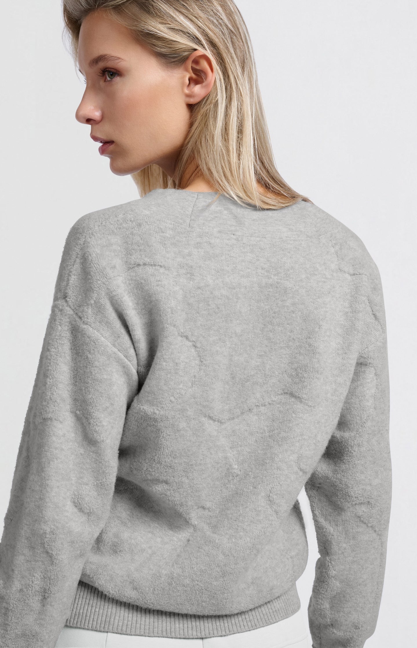 Knitted sweater with V-neck and textured pattern