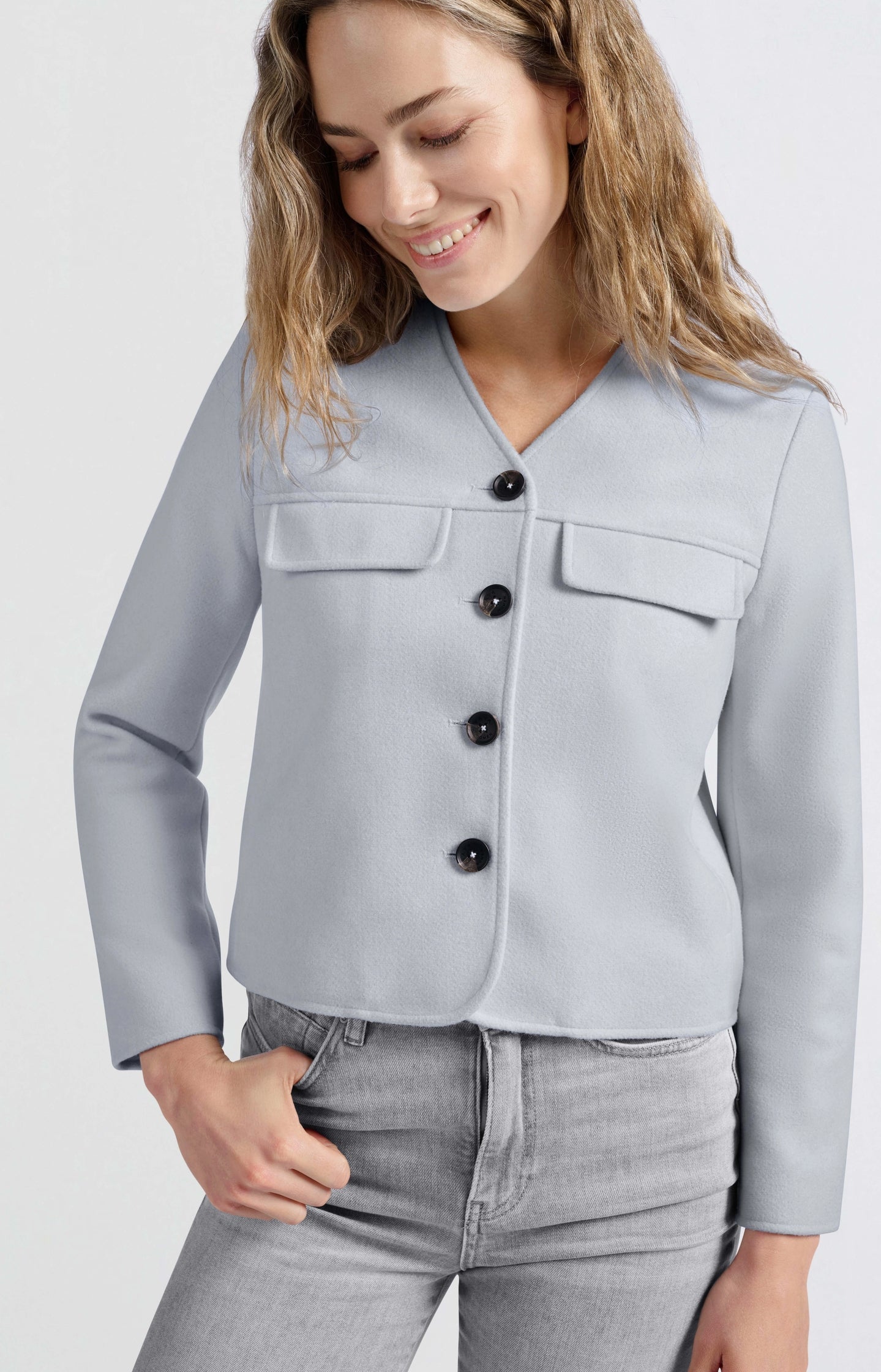 Soft short jacket with chest pockets and button closure